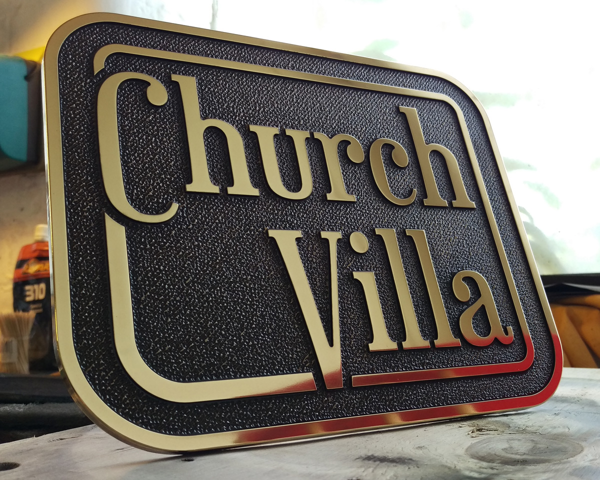 Bespoke house name plaque - brass with a patinated, textured background.