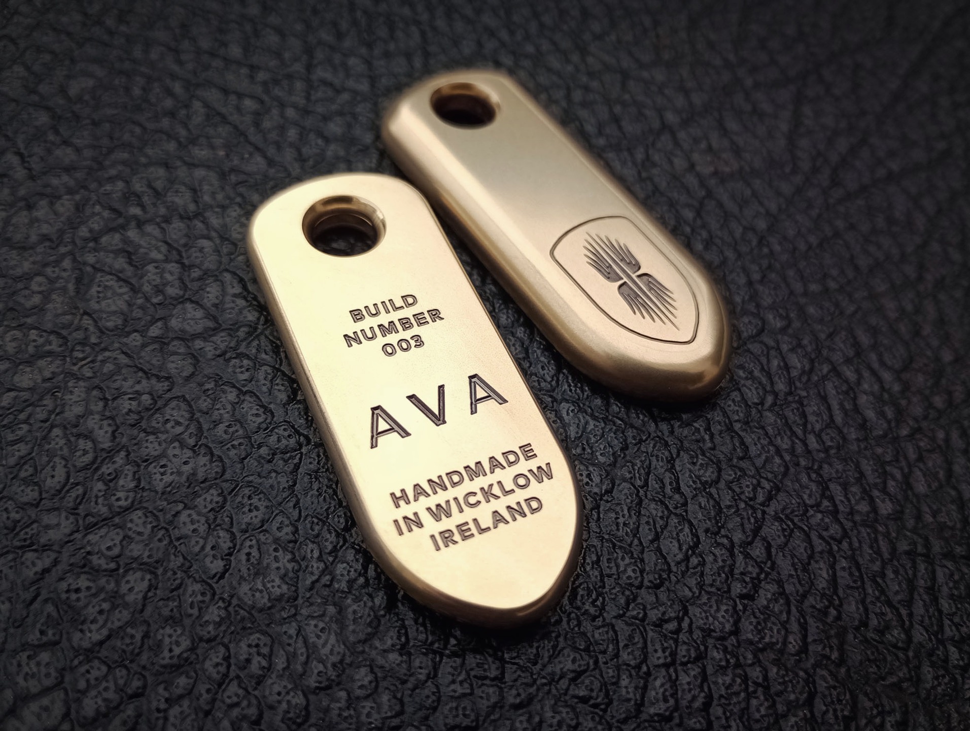 A set of six bespoke and individually numbered brass key-fobs and a hood badge made for www.studioava.com